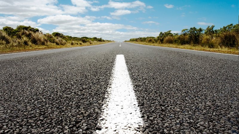 vertical-shot-asphalt-road-blue-sky